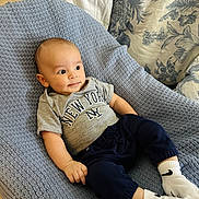 Luka joined the competition — help win amazing prizes! baby, child, infant, clothing, tshirt, pants, socks, chair, fabric, texture, pattern, floral, portrait, indoor, cute, smile, relaxed, person, cozy, new_york
