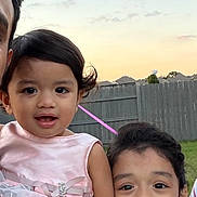 Avni Asnala is registered to the contest to win money with this photo: child, children, outdoor, dressed_up, fence, sunset, sky, grass, smiling, portrait, family, girl, toddler, happy, cute, person, clothing, nature, daytime, people