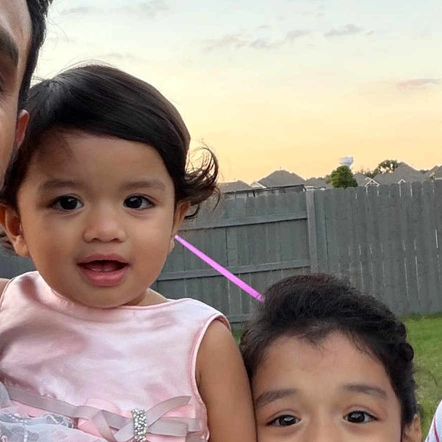 Avni Asnala is registered to the contest to win money with this photo: child, children, outdoor, dressed_up, fence, sunset, sky, grass, smiling, portrait, family, girl, toddler, happy, cute, person, clothing, nature, daytime, people