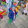 children, costumes, masks, outdoor, pavement, colorful, playful, group, kids, bird_costume, feathers, handmade, jackets, shoes, parade, event, friends, crafts, fun, daytime