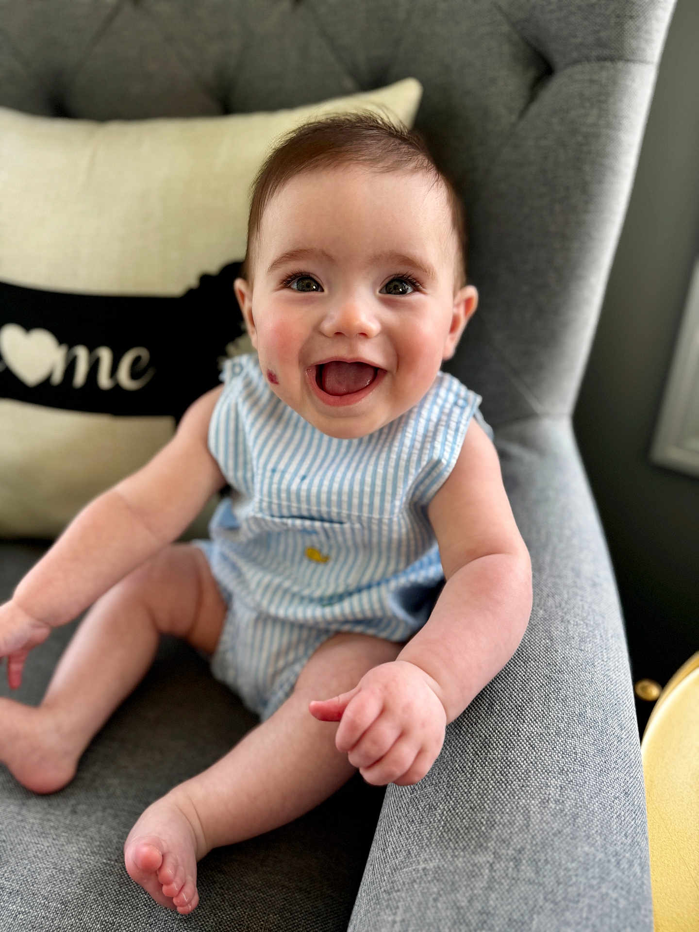 Bentley Orchard is registered to the contest to win money with this photo: baby, child, smiling, happy, cute, infant, portrait, blue_striped_outfit, sitting, chair, cushion, indoor, home, face, skin, arm, leg, foot, expression, person