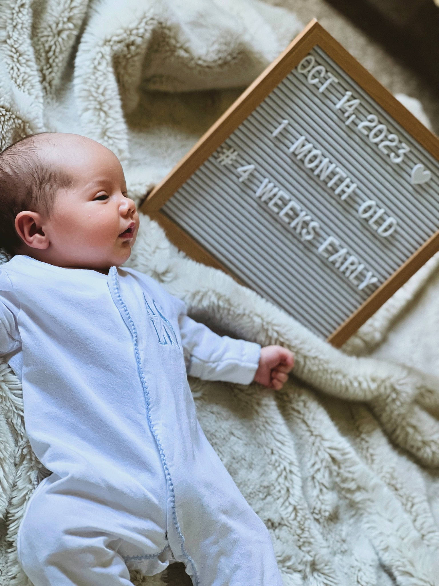 Adam is registered to the contest to win money with this photo: art, baby, baby_toddler_clothing, beauty, child, comfort, font, gesture, happy, human, people, person, product, rectangle, sitting, skin, sleeve, textile, toddler, wood