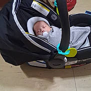 Elijah joined the competition — help win amazing prizes! baby, baby_carrier, bag, blanket, buckle, car_seat, child, clothing, face, floor, handle, head, indoor, infant, pacifier, portrait, sleeping, strap, tile_floor, toy_clip