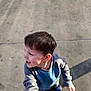 Jonathan is registered to the contest to win money with this photo: child, boy, sweater, hand_holding, outdoor, concrete, shadow, casual_clothing, short_hair, happy, young, person, daylight, looking_away, playing, standing, fun, interaction, childhood, casual