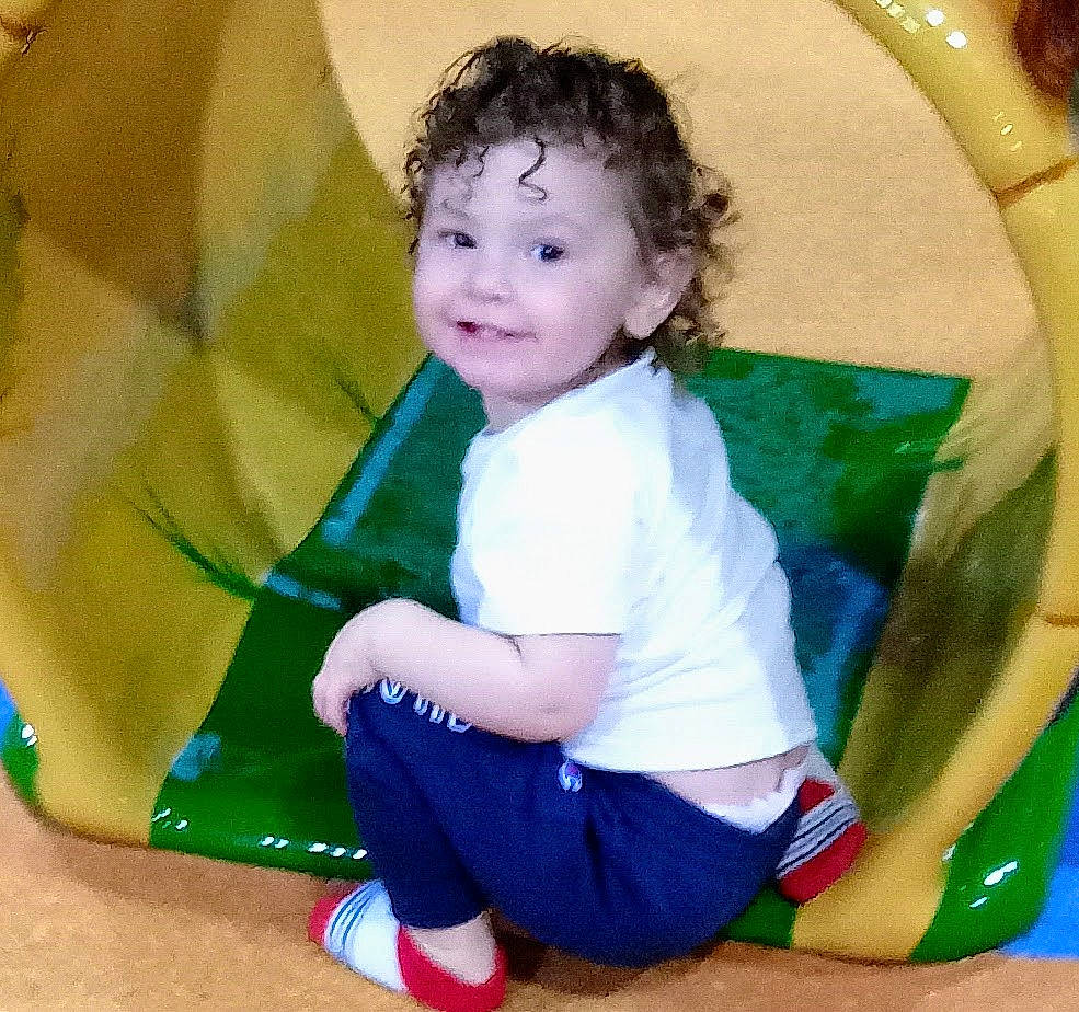 Jaxson is registered to the contest to win money with this photo: baby_toddler_clothing, child, circle, electric_blue, eye, fun, grass, happy, human_body, iris, joy, leisure, pattern, people_in_nature, person, play, recreation, sitting, sleeve, smile