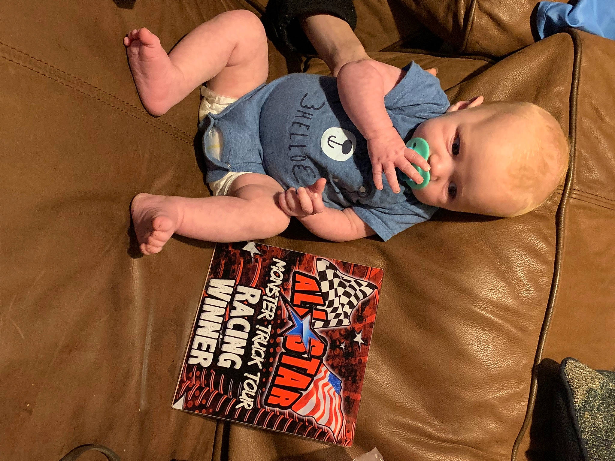 Braxton River is registered to the contest to win money with this photo: baby_products, child, comfort, couch, elbow, finger, fun, gesture, hand, hat, human, human_leg, joint, nail, orange, person, shorts, sitting, t_shirt, thigh