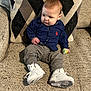 Miles joined the competition — help win amazing prizes! toddler, child, person, sitting, couch, pillow, toy, white_sneakers, pants, shirt, indoor, home, furniture, footwear, cute, baby, small_toy, casual_clothing, patterned_pillow, relaxing