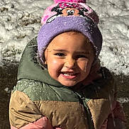 Tre'Me is registered to the contest to win money with this photo: child, smiling, winter_clothing, hat, pom_pom, minnie_mouse, snow, outdoor, cold_weather, jacket, colorful, happy, face, portrait, cute, young_child, playful, snowy_ground, fun, warm