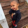 Tre'Me is registered to the contest to win money with this photo: child, curly_hair, black_sweater, moose_design, red_plaid_pants, black_shoes, wooden_steps, outdoor, smiling, cute, portrait, fall_leaves, grass, playful, standing, cozy_clothing, young_child, fun, happy, nature
