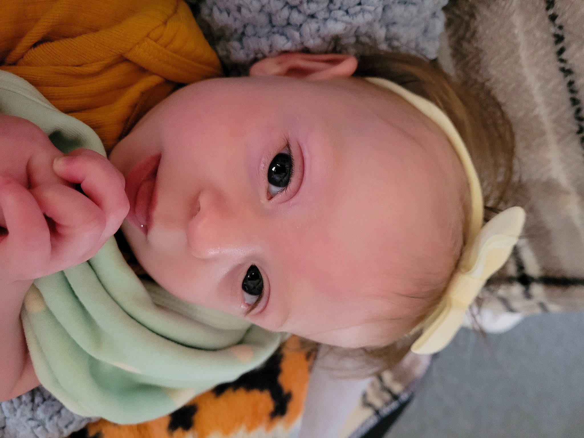 Eliana is registered to the contest to win money with this photo: baby, baby_toddler_clothing, banana, cheek, child, chin, eye, eyebrow, eyelash, face, facial_expression, gesture, head, iris, lip, mouth, nose, person, plant, skin