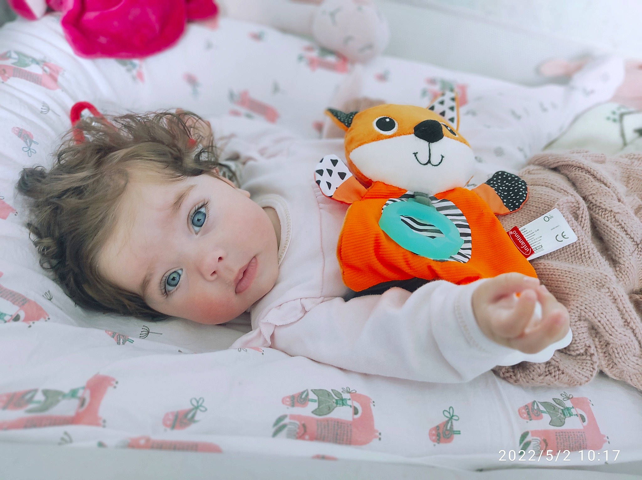 Olivia participe au concours pour gagner de l'argent avec cette photo : baby, baby_products, baby_toddler_clothing, bedding, cheek, child, comfort, doll, happy, linens, pattern, person, pink, product, room, skin, sleeve, stuffed_toy, textile, toddler
