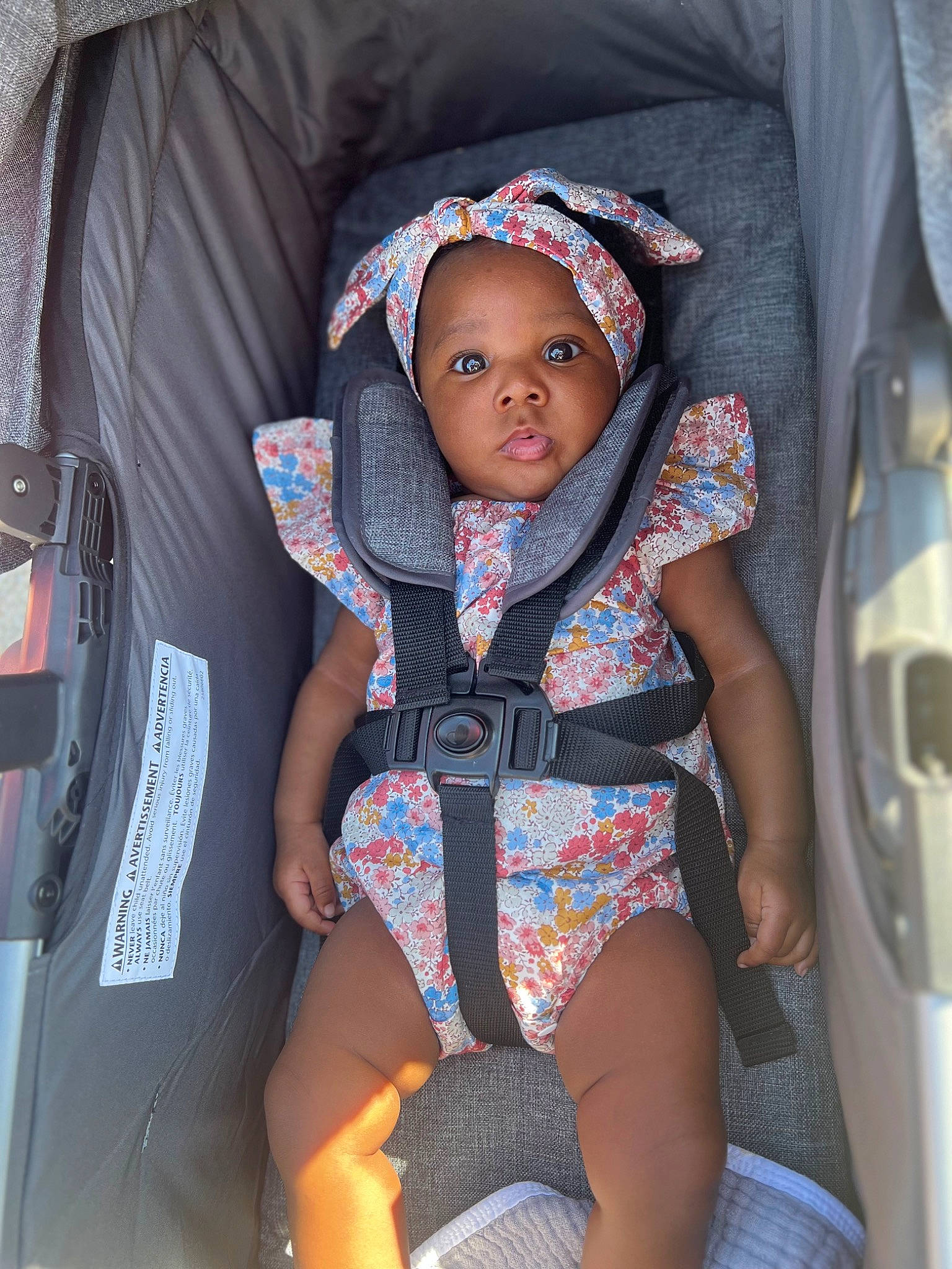 Kennedy is registered to the contest to win money with this photo: baby, baby_carriage, baby_products, baby_safety, baby_toddler_clothing, car_seat, child, comfort, electric_blue, eye, fashion_accessory, human_body, human_leg, knee, mouth, person, personal_protective_equipment, sitting, sleeve, thigh