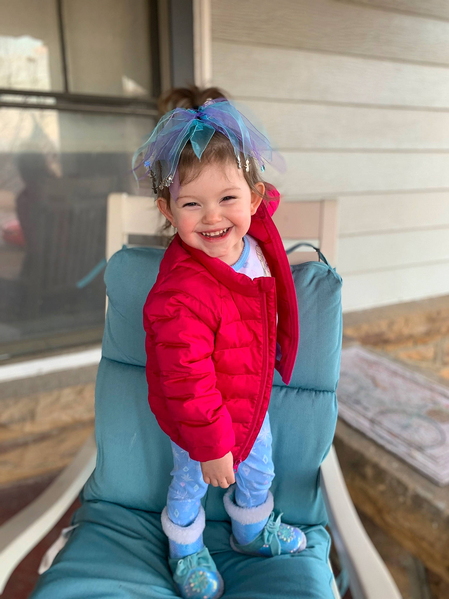 Peyton is registered to the contest to win money with this photo: baby_toddler_clothing, child, electric_blue, fun, grass, happy, jacket, joy, leg, leisure, magenta, person, personal_protective_equipment, recreation, sitting, skin, sleeve, smile, toddler, travel