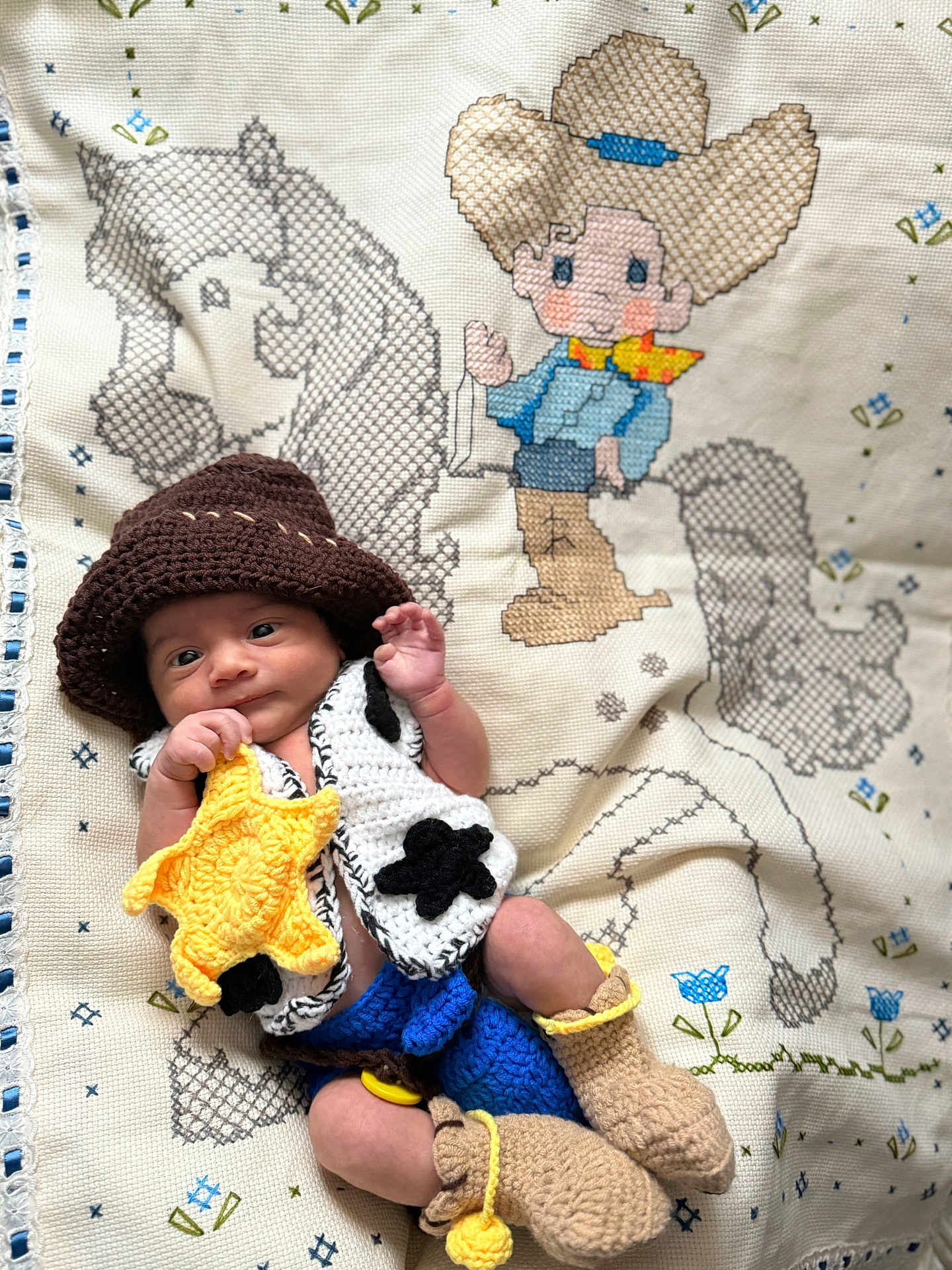 Emilio is registered to the contest to win money with this photo: baby, infant, crochet, hat, vest, boots, yellow_star, cowboy, blanket, cross_stitch, horse, child, cute, handmade, knitwear, fabric, pattern, lying_down, portrait, smiling
