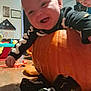 Greyson joined the competition — help win amazing prizes! baby, child, pumpkin, indoor, skeleton_outfit, smiling, playful, toy, floor, person, sock, black_clothing, orange, happy, infant, cute, holiday, fun, home, family