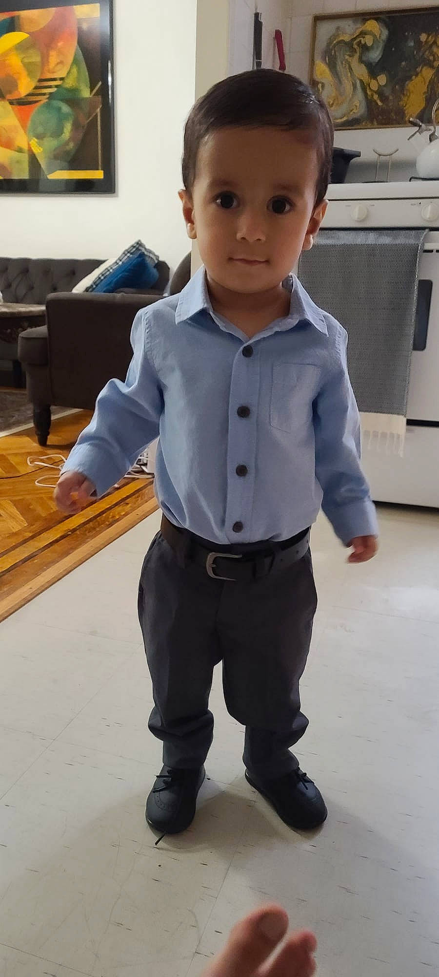 Darius is registered to the contest to win money with this photo: bench, blazer, bow_tie, clothing, collar, couch, denim, dress_shirt, eye, flooring, formal_wear, gesture, joint, leg, person, photograph, picture_frame, sleeve, standing, tie