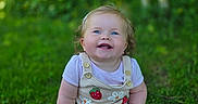 Evalyn joined the competition — help win amazing prizes! baby, child, grass, outdoor, smiling, happy, blue_eyes, cute, nature, greenery, sunlight, sitting, clothing, strawberry, flowers, portrait, infant, toddler, daylight, casual