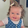 baby, child, smiling, blue_eyes, bow, dress, checkered_pattern, indoor, portrait, cute, happy, infant, childhood, face, hair_clip, female, people, skin, toddler, young_child