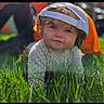 Evalyn joined the competition — help win amazing prizes! baby, child, grass, outdoor, cap, curly_hair, crawling, greenery, cute, sunlight, portrait, smile, person, headwear, nature, young_child, happy, casual_clothing, daylight, background_blur