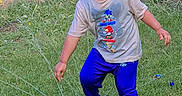Kabir joined the competition — help win amazing prizes! child, boy, outdoor, grass, sprinkler, water, playing, blue_pants, blue_shoes, tshirt, smiling, garden, backyard, brick_wall, water_spray, fun, happy, summer, foot_on_sprinkler, casual_clothing