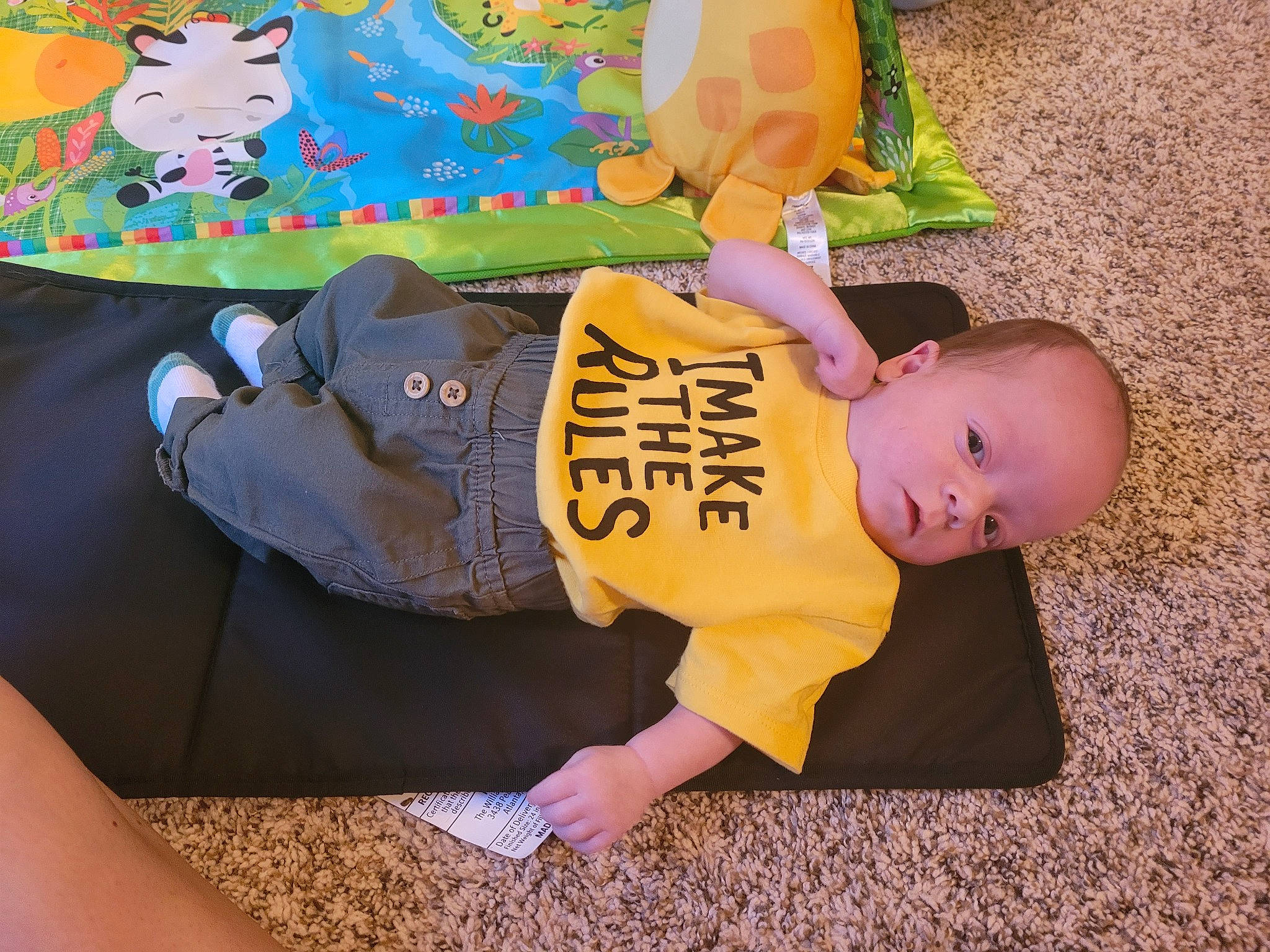 Christian is registered to the contest to win money with this photo: baby, baby_products, baby_toddler_clothing, bag, child, comfort, flooring, foot, fun, grass, happy, leisure, luggage_and_bags, person, play, room, sitting, stuffed_toy, thigh, toddler