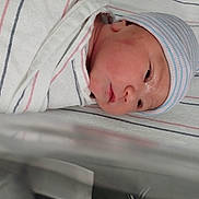 Gwenivere is registered to the contest to win money with this photo: newborn, baby, infant, hat, blanket, hospital, bassinet, striped, sleeping, face, skin, child, wrapped, cute, portrait, headwear, peaceful, closeup, lying, resting
