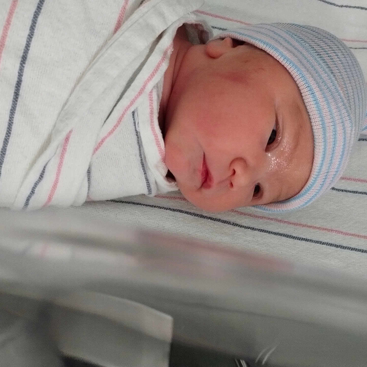 Gwenivere is registered to the contest to win money with this photo: baby, bassinet, blanket, child, closeup, cute, face, hat, headwear, hospital, infant, lying, newborn, peaceful, portrait, resting, skin, sleeping, striped, wrapped