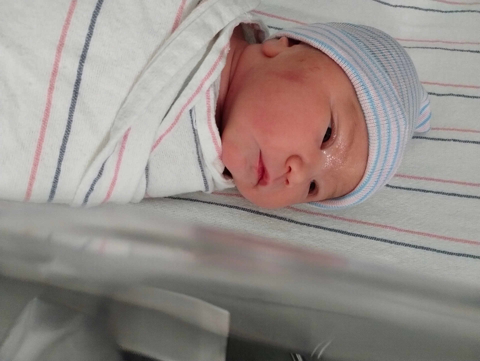 Gwenivere is registered to the contest to win money with this photo: newborn, baby, infant, hat, blanket, hospital, bassinet, striped, sleeping, face, skin, child, wrapped, cute, portrait, headwear, peaceful, closeup, lying, resting