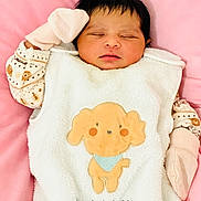 Mary-Abilene participe au concours pour gagner de l'argent avec cette photo : apparel, baby, baby_clothes, cartoon_dog, child, cozy, cute, cute_animal, face, indoors, infant, mitten, newborn, peaceful, pink_background, portrait, resting, sleeping, soft, white_outfit