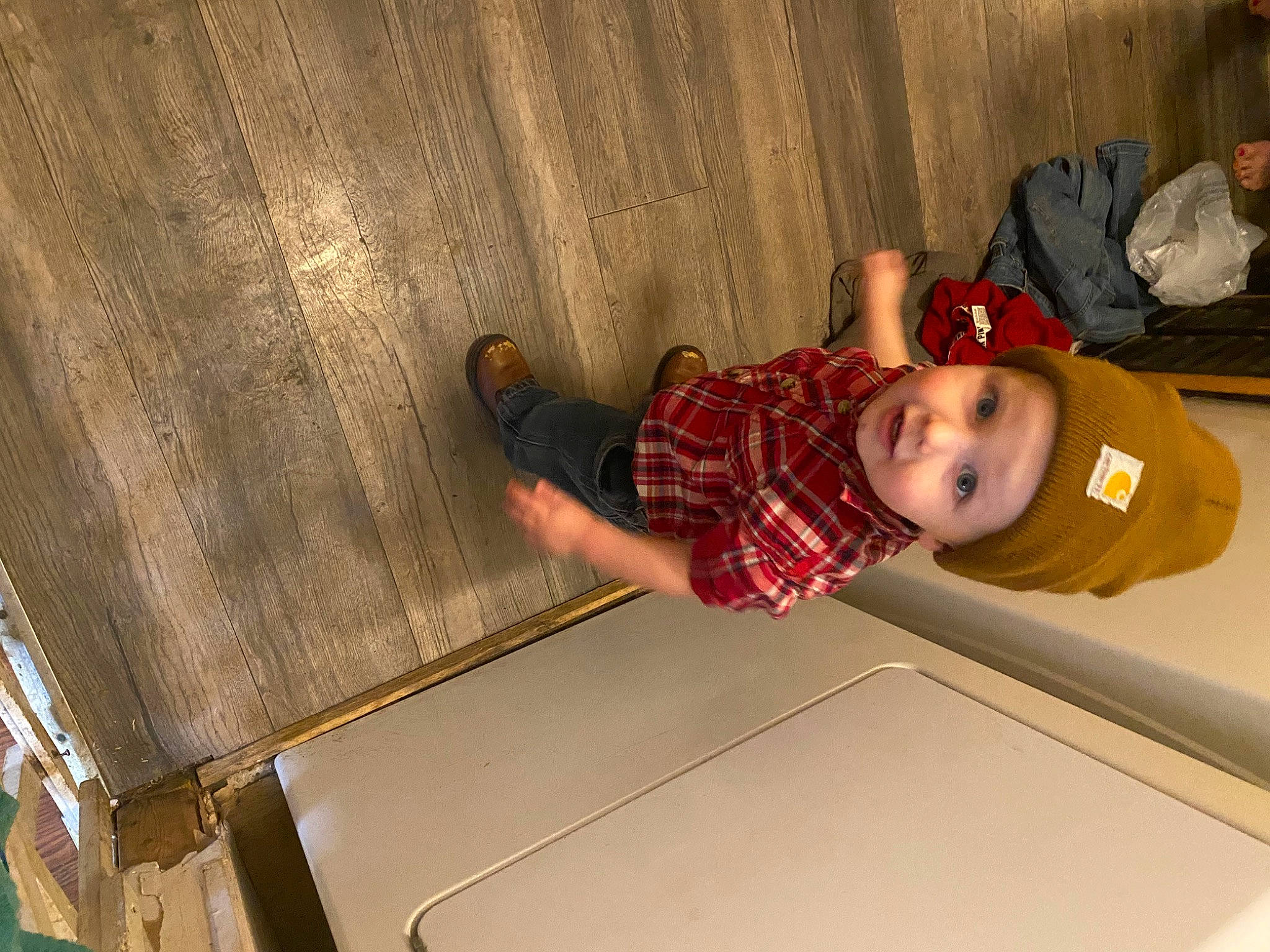Brayden is registered to the contest to win money with this photo: baby_toddler_clothing, child, flooring, fun, hardwood, hat, headwear, person, room, sitting, smile, toddler, wood