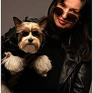 Lisa Long joined the competition — help win amazing prizes! accessories, black_clothing, brown_hair, cool, cute, dog, eyewear, fashion, fur, indoor, leather_jacket, long_hair, matching, pet, portrait, small_dog, smile, studio, sunglasses, woman