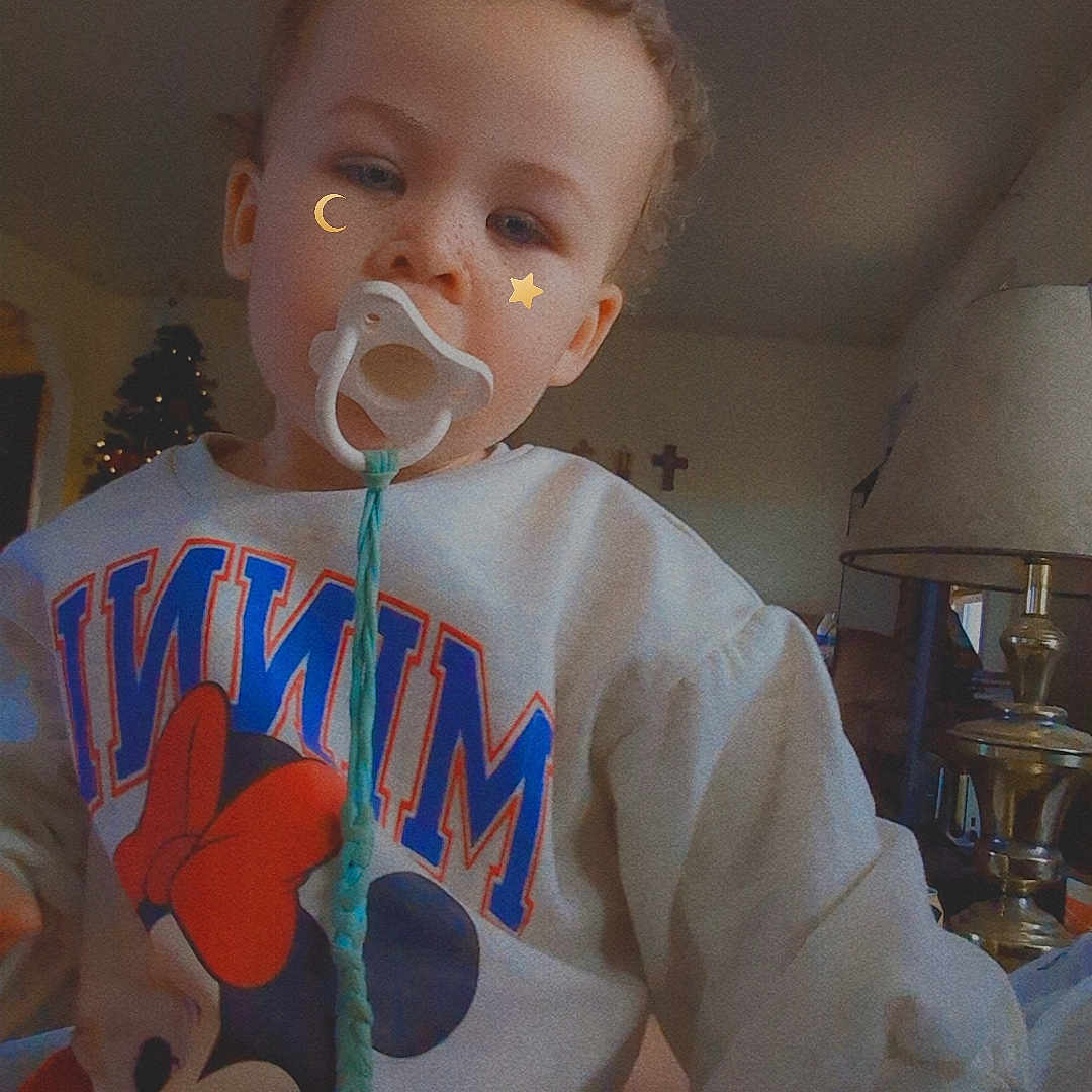 Kida joined the competition — help win amazing prizes! child, christmas_tree, clothing, cozy, curly_hair, cute, face, filter, freckles, home, indoor, lamp, minnie_mouse, pacifier, person, portrait, sweater, toddler, toy, young_child