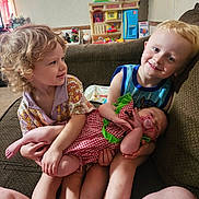 Bristlynn Miller is registered to the contest to win money with this photo: baby, children, couch, dress, family, happy, home, indoors, living_room, pacifier, playroom, portrait, preschooler, shirt, siblings, sitting, smiling, stuffed_animal, toddler, toy_kitchen