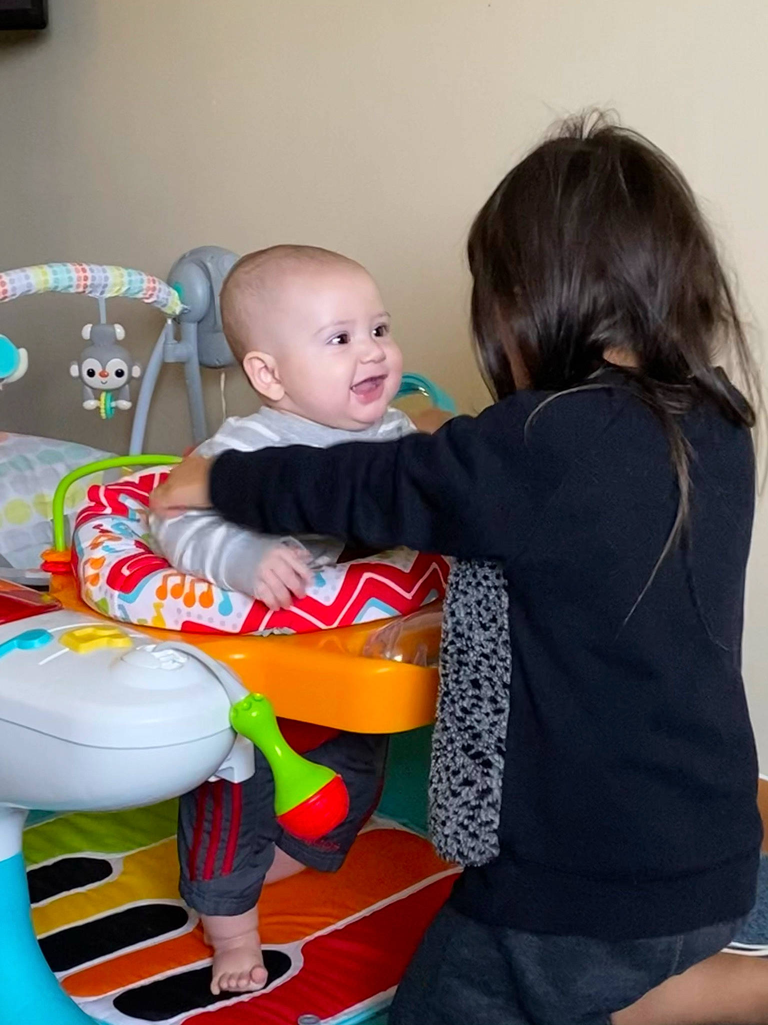 Axl is registered to the contest to win money with this photo: baby, baby_products, baby_toddler_clothing, baby_toys, child, comfort, human_body, lap, love, person, plastic, play, product, sitting, sock, toddler