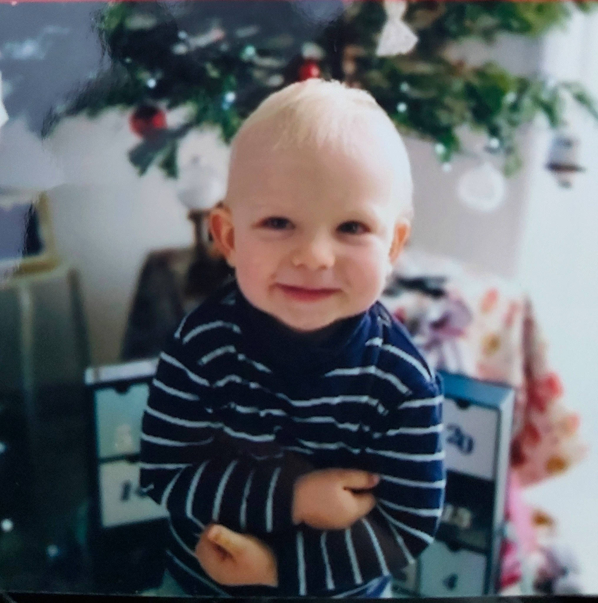 Nino participe au concours pour gagner de l'argent avec cette photo : baby, baby_toddler_clothing, cheek, child, christmas, christmas_eve, christmas_tree, event, facial_expression, fun, happy, holiday, human_body, iris, joy, person, room, sitting, sleeve, smile