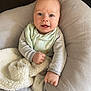 Thomas is registered to the contest to win money with this photo: baby, infant, smile, blue_eyes, blanket, cushion, bib, striped_clothing, soft_texture, cozy, comfort, child, portrait, indoor, cute, happy, young_child, person, head, hand
