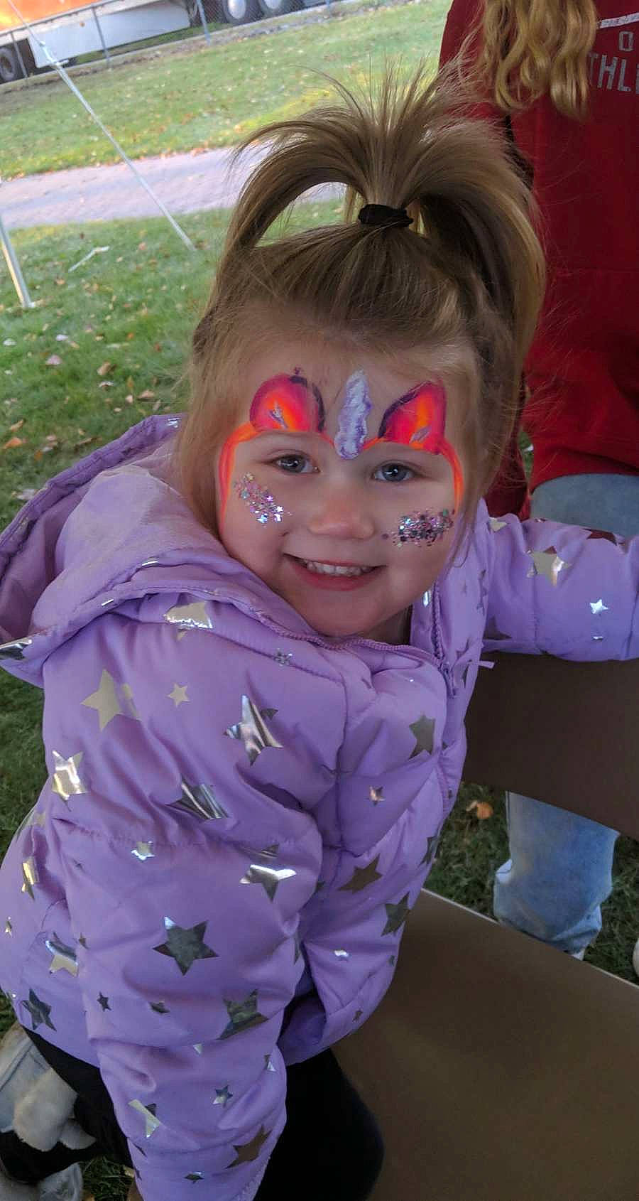 Malia joined the competition — help win amazing prizes! child, costume, event, eyewear, fictional_character, fun, glove, grass, happy, hoodie, joy, laugh, mask, mouth, person, personal_protective_equipment, pink, purple, smile, toddler