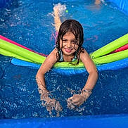 Valentina Rose joined the competition — help win amazing prizes! child, pool, water, smiling, splashing, swimming, inflatable_pool, pool_noodles, wet_hair, summer, fun, outdoor, play, blue, recreation, leisure, happy, person, kid, vacation