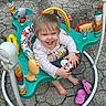 animal_toys, baby, barefoot, child, clothing, colorful, cute, footwear, happy, jumper, outdoor, pavement, person, pink_crocs, plastic, playful, seat, smiling, toddler, toy