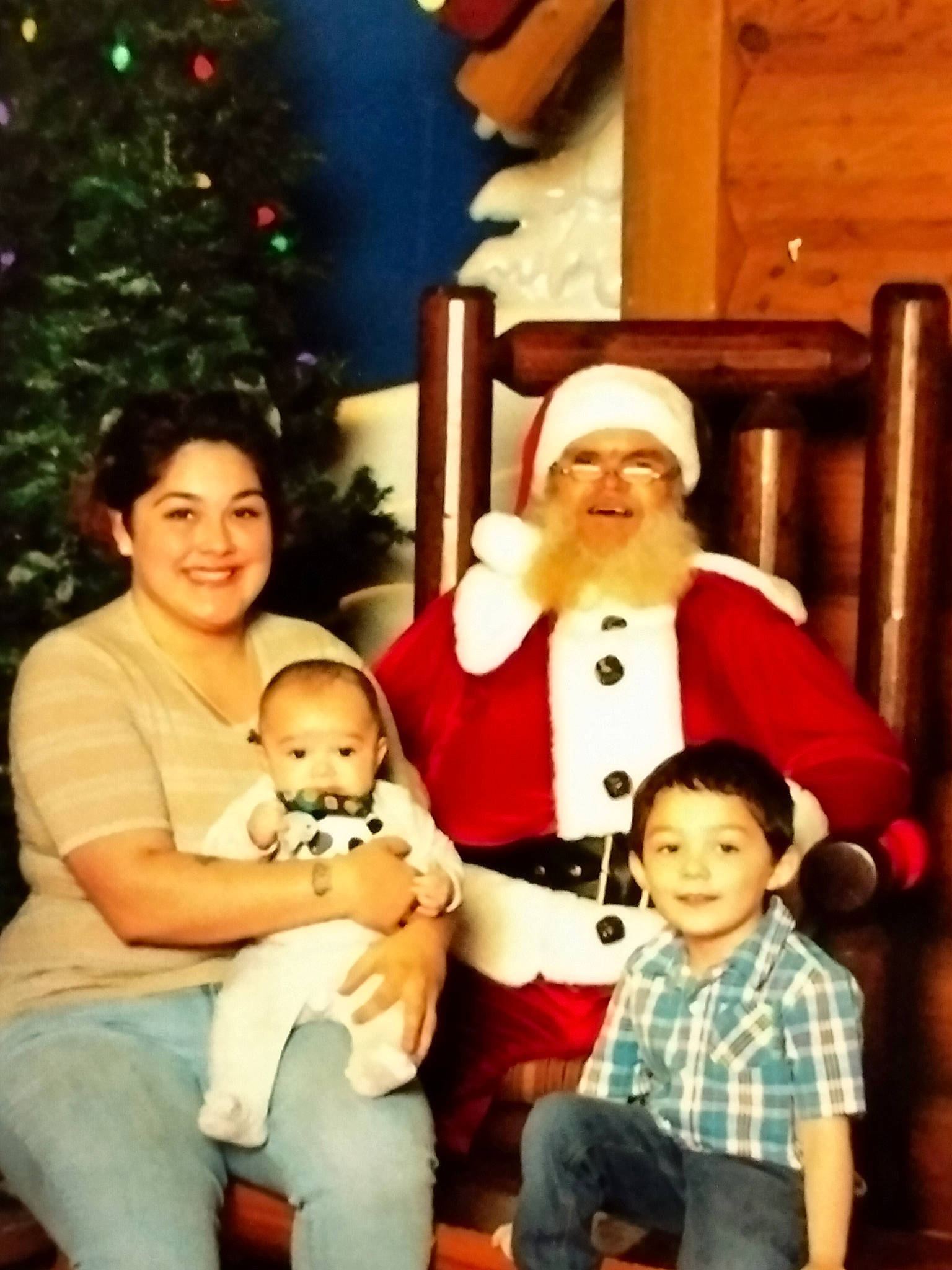 Augustine joined the competition — help win amazing prizes! child, christmas, christmas_decoration, christmas_tree, event, face, fun, happy, hat, head, headwear, holiday, jeans, joy, lap, people, person, santa_claus, sitting, smile