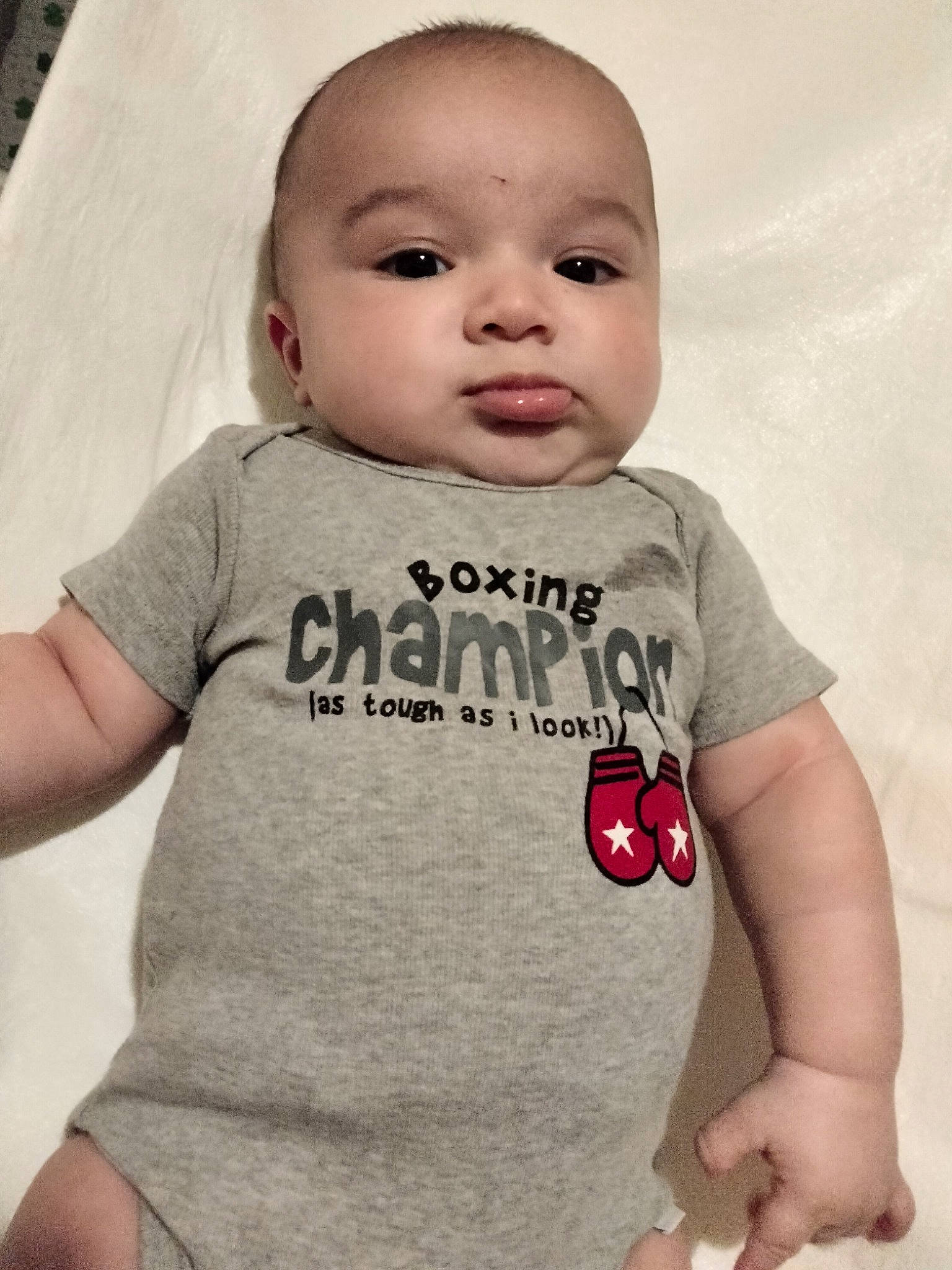 Augustine is registered to the contest to win money with this photo: baby, baby_toddler_clothing, cheek, chest, child, cool, eyelash, gesture, happy, lip, mouth, neck, nose, pattern, person, skin, sleeve, smile, t_shirt, thumb