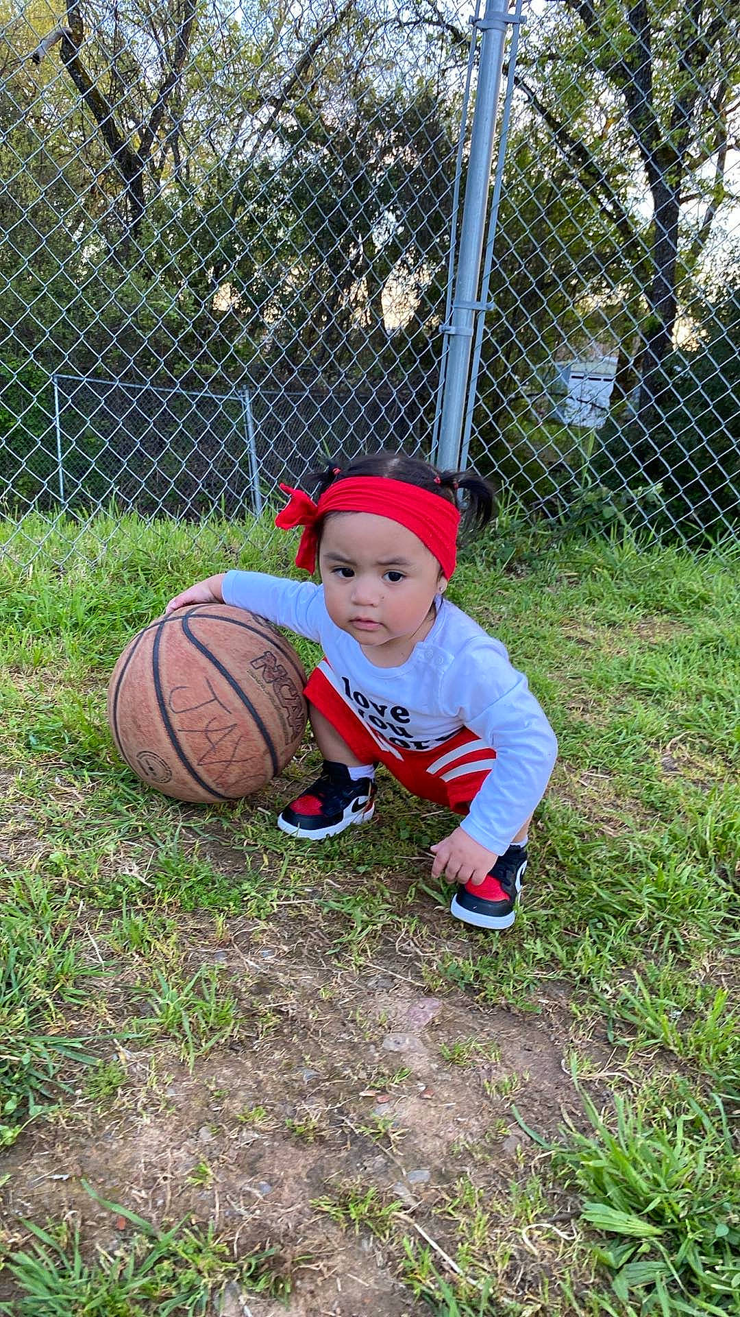 Xitlali is registered to the contest to win money with this photo: baby_toddler_clothing, ball, face, fence, football, grass, hat, headwear, lawn, leisure, mesh, people_in_nature, person, plant, player, sports, sports_equipment, sports_gear, team_sport, toddler