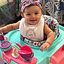 baby, child, headband, bib, walker, toy, smile, happy, indoor, person, infant, furniture, colorful, playtime, cute, face, arm, seat, pattern, floor
