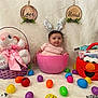 Mary joined the competition — help win amazing prizes! baby, bunny_ears, pink_bowl, plush_bunny, easter_eggs, purple_basket, red_basket, elmo, toys, pastel_colors, wooden_plaques, love_sign, blessed_sign, soft_background, cute, festive, indoor, child, smiling, celebration