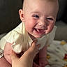 Charlotte joined the competition — help win amazing prizes! baby, smiling, face, hand, person, infant, clothing, skin, cute, happy, child, portrait, expression, indoors, blanket, holding, warm, soft, young, sitting