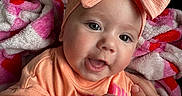 Charlotte joined the competition — help win amazing prizes! baby, child, smiling, headband, bow, blanket, plush_toy, giraffe, hand, bracelet, person, indoors, cute, closeup, portrait, happy, pink, orange_clothing, soft_texture, infant