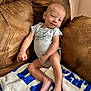 Creed joined the competition — help win amazing prizes! baby, infant, couch, blanket, brown, blue, smile, cute, relaxing, indoors, child, person, clothing, feet, happy, home, soft, comfortable, portrait, skin