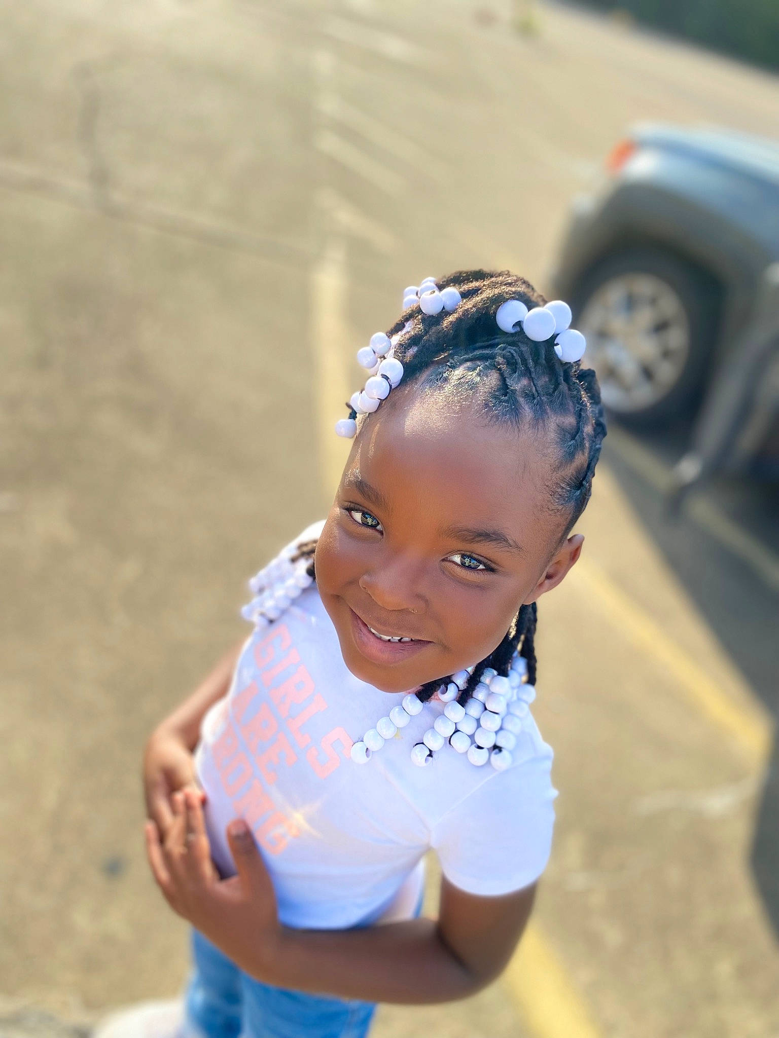 Ashlynn joined the competition — help win amazing prizes! bun, child, electric_blue, eye, fashion_accessory, fun, grass, happy, headband, headpiece, jewellery, joy, leisure, person, portrait_photography, recreation, sitting, smile, tire, toddler