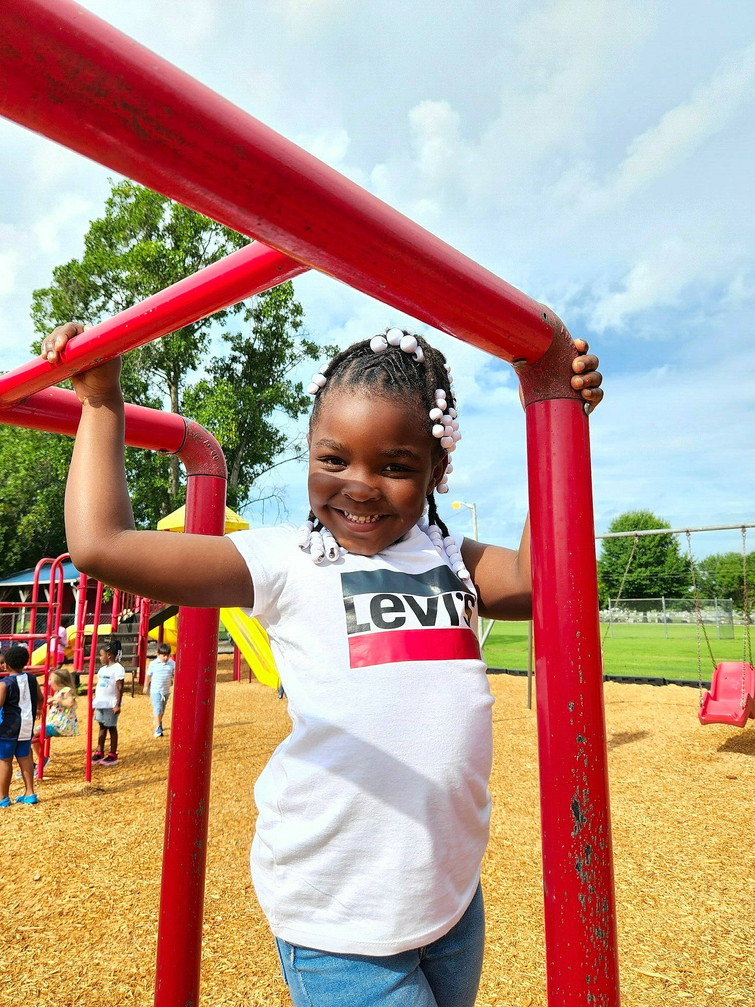 Ashlynn is registered to the contest to win money with this photo: chute, city, cloud, fun, gesture, happy, joy, leisure, outdoor_play_equipment, outdoor_recreation, people_in_nature, person, playground, playground_slide, recreation, sky, smile, swing, travel, tree