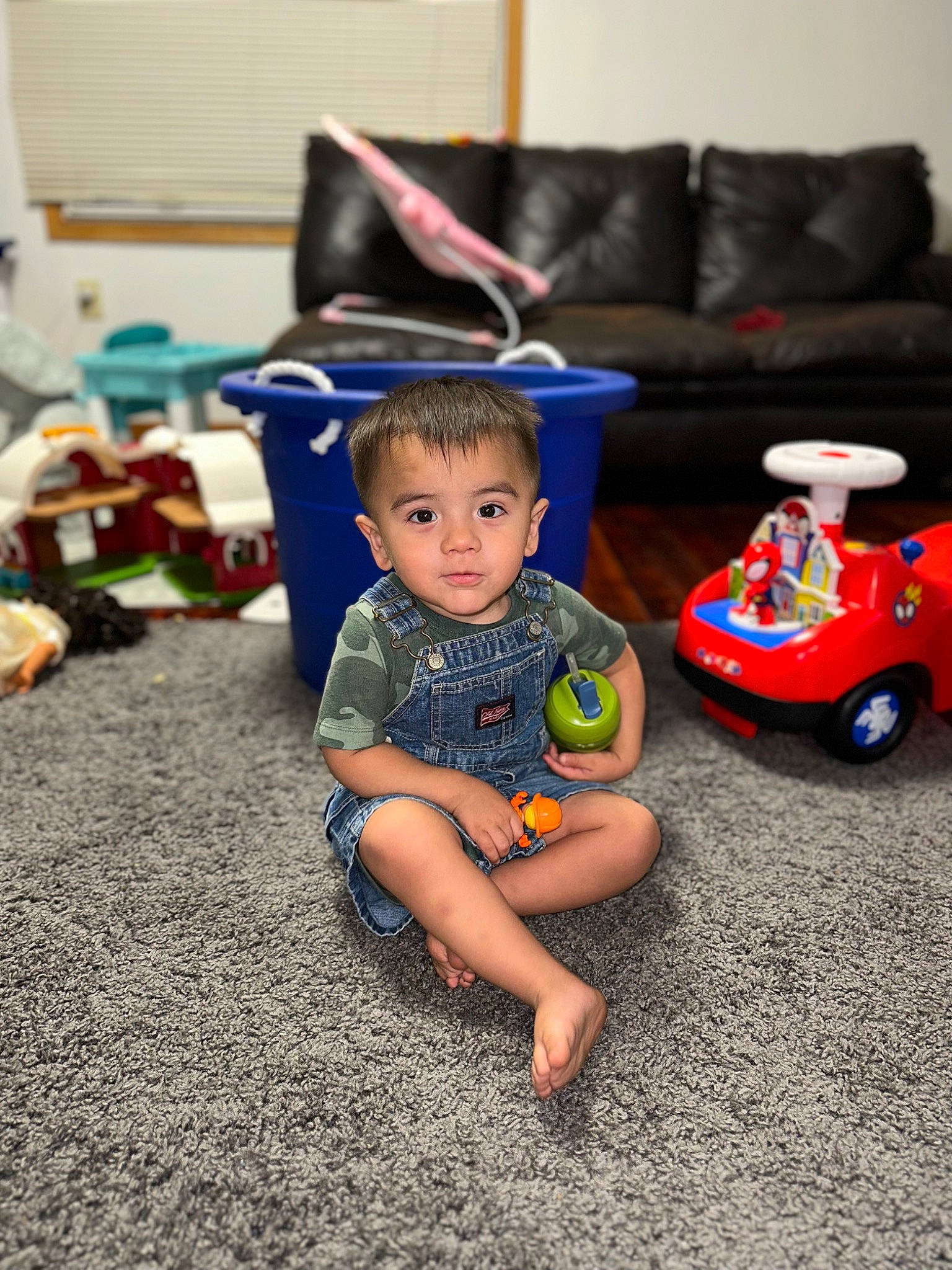 Alvaro is registered to the contest to win money with this photo: baby, child, event, flooring, fun, grass, happy, leisure, person, play, public_space, recreation, riding_toy, room, shorts, sitting, t_shirt, toddler, toy, vacation